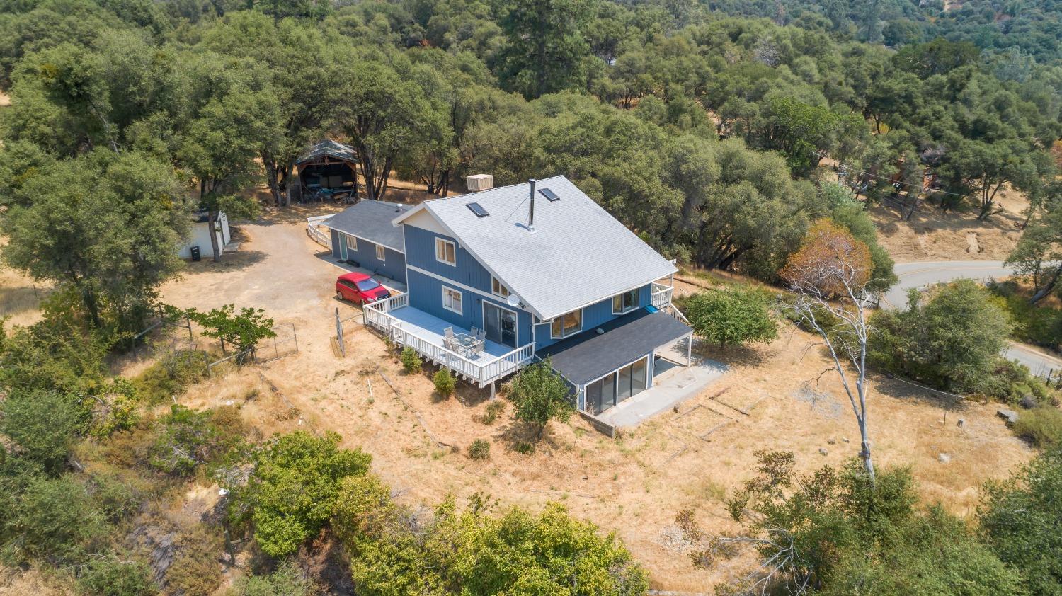 40707 Jean Road East Oakhurst, CA 93644 - Photo 1 of 44 a view of a house with a yard covered in snow