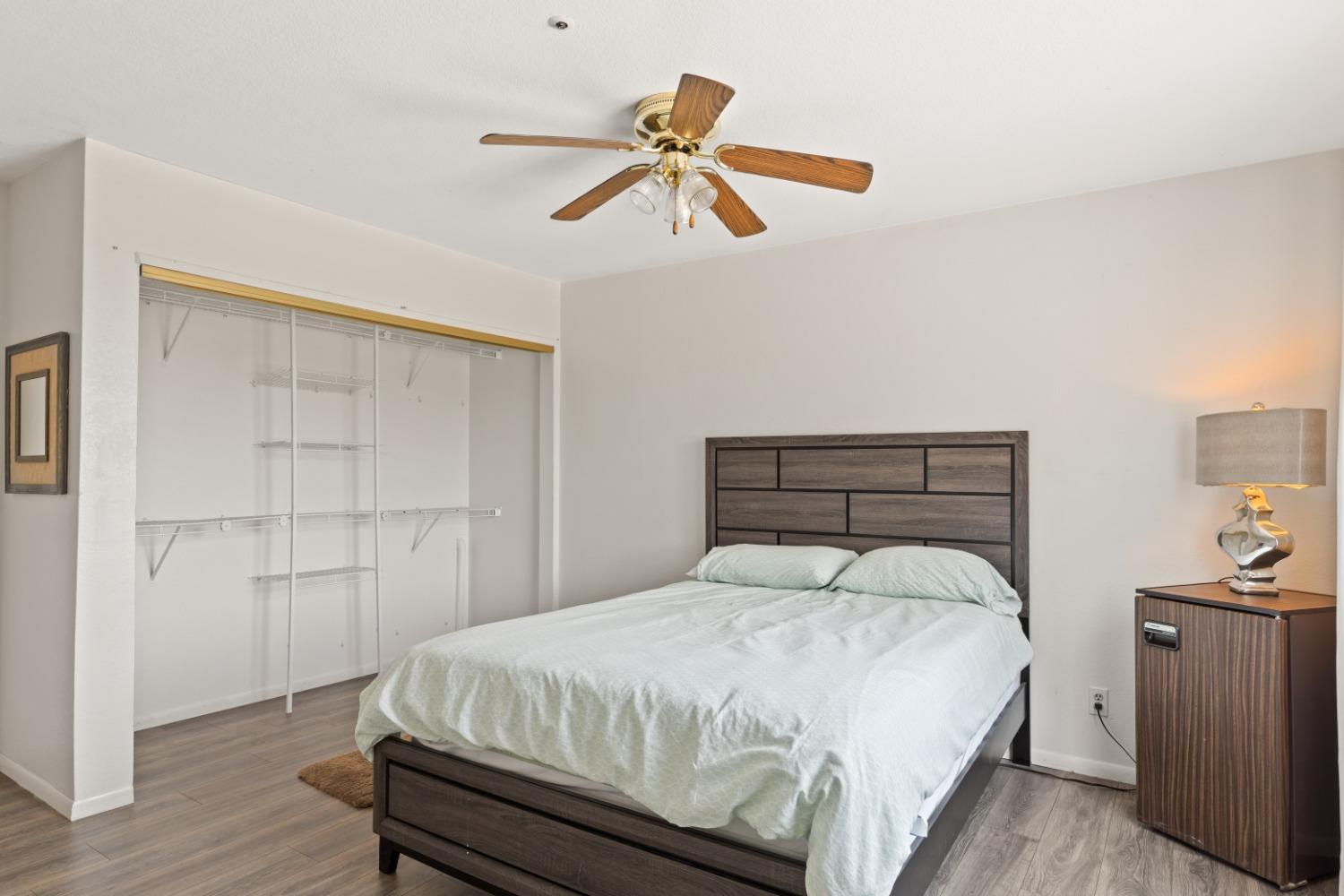 40707 Jean Road East Oakhurst, CA 93644 - Photo 12 of 44 a bedroom with a bed and a chandelier