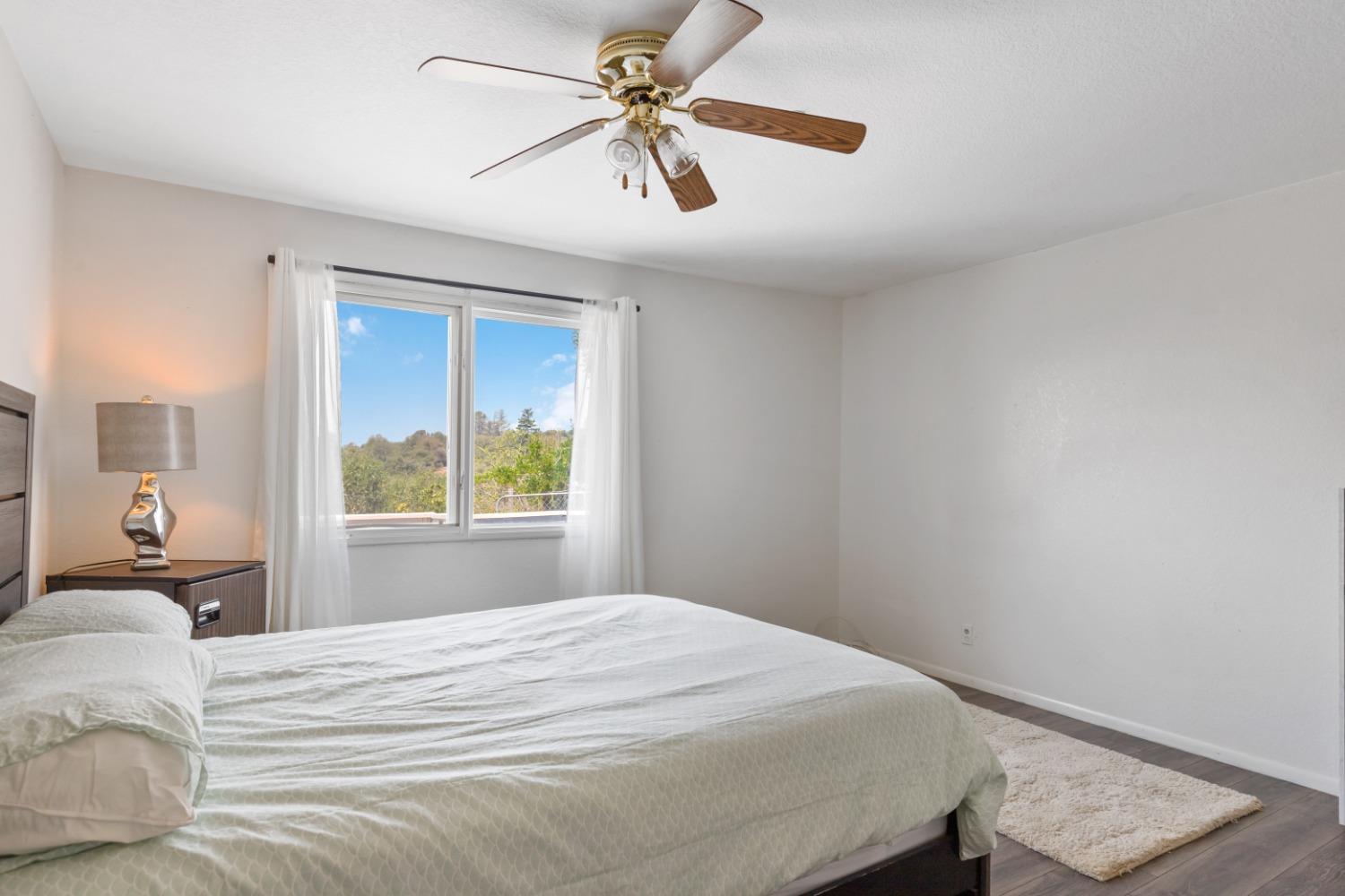 40707 Jean Road East Oakhurst, CA 93644 - Photo 13 of 44 a bedroom with a bed and a window