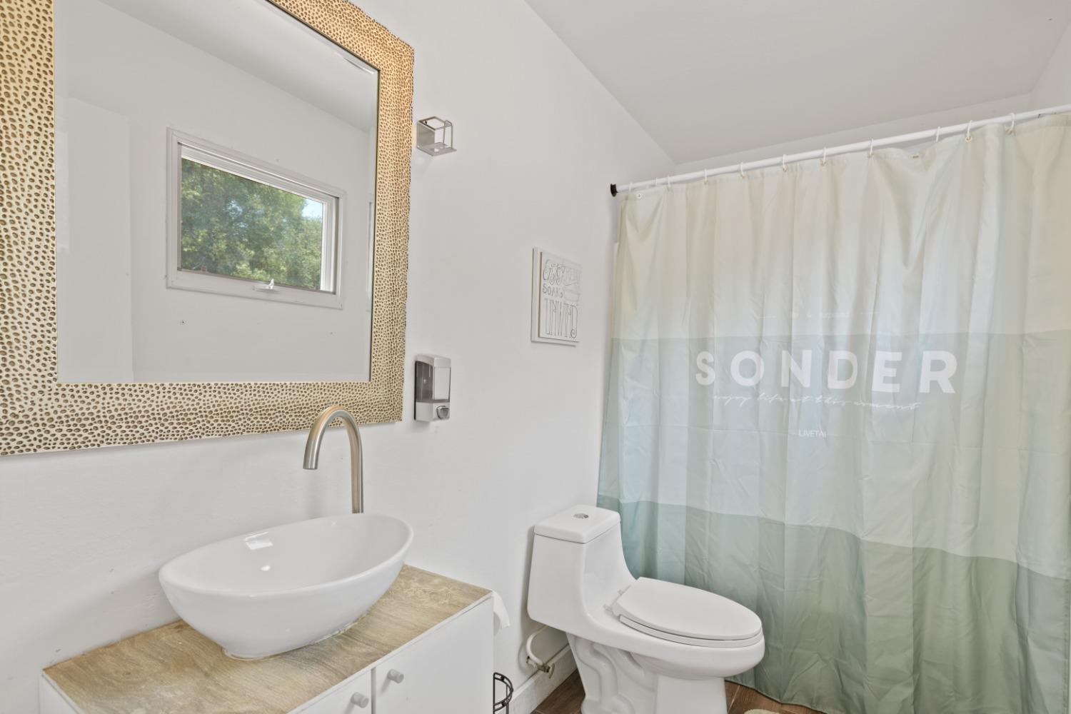 40707 Jean Road East Oakhurst, CA 93644 - Photo 20 of 44 a bathroom with a toilet a sink and a shower