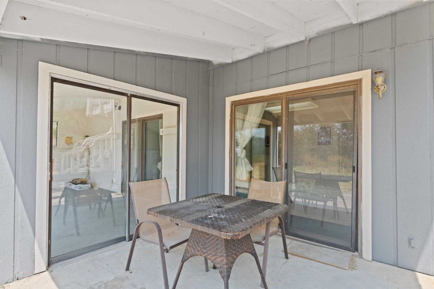 40707 Jean Road East Oakhurst, CA 93644 - Photo 27 of 44 a dining room with a wooden table and glass door