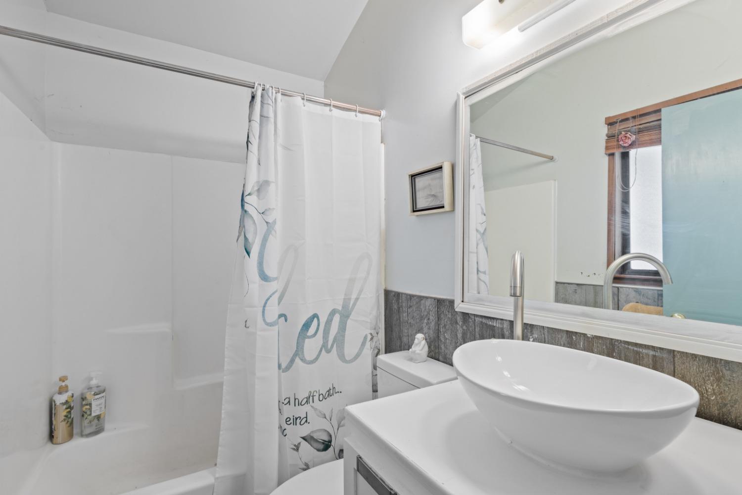40707 Jean Road East Oakhurst, CA 93644 - Photo 32 of 44 a bathroom with a sink a toilet and shower