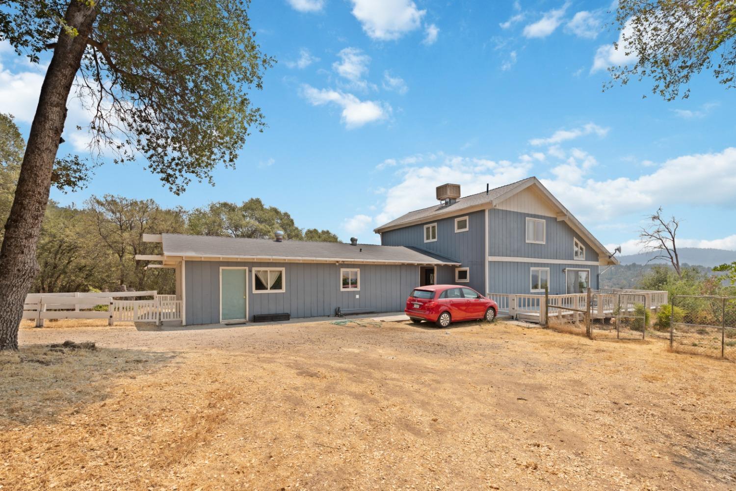 40707 Jean Road East Oakhurst, CA 93644 - Photo 42 of 44 a front view of a house with a yard