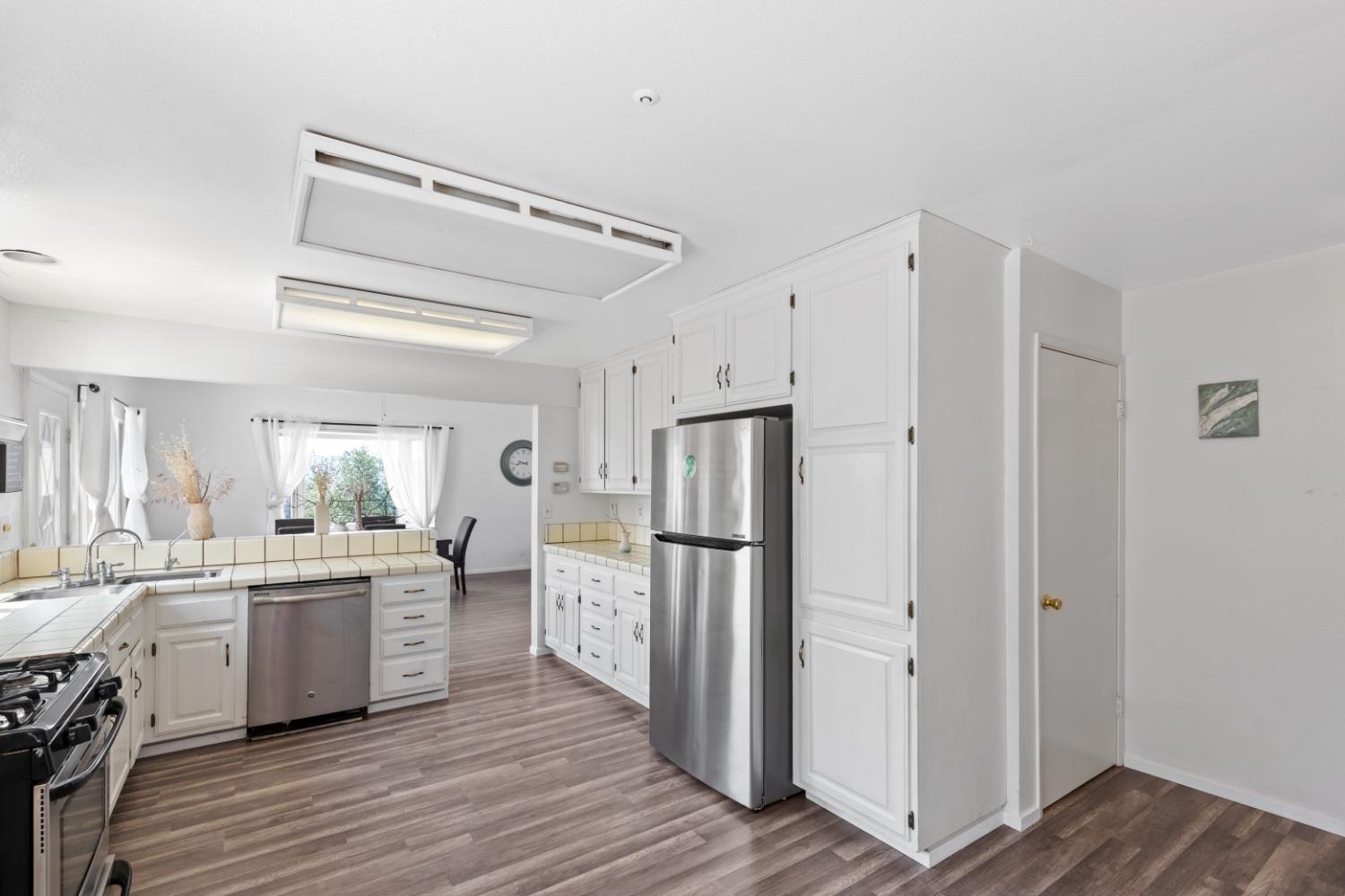 40707 Jean Road East Oakhurst, CA 93644 - Photo 7 of 44 a kitchen with white cabinets and white appliances