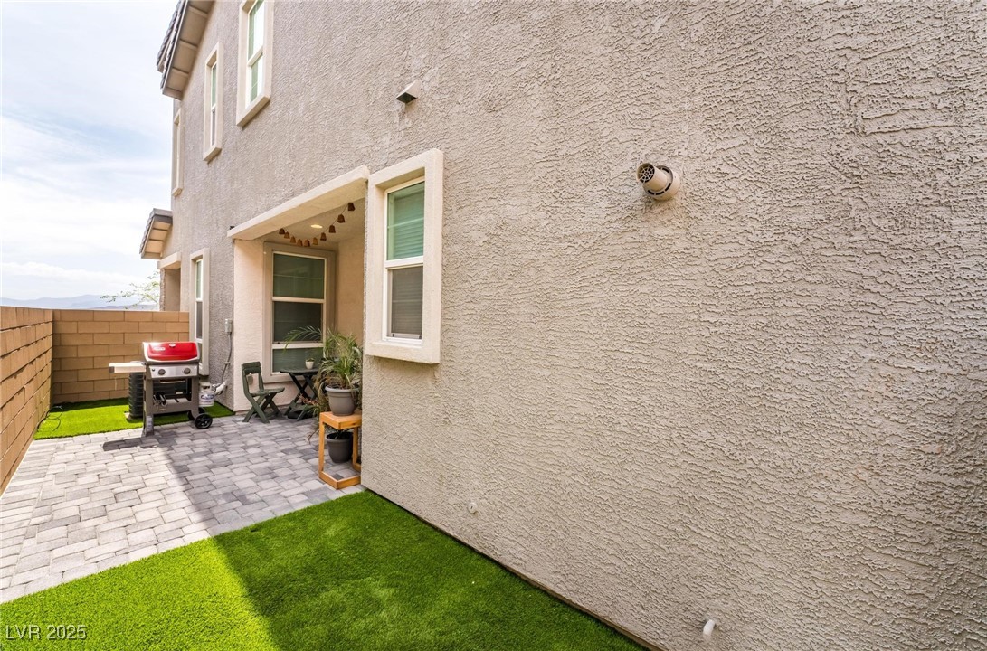 128 Kimberlite Drive Henderson, NV 89011 - Photo 30 of 55 View of property exterior with stucco siding and a patio