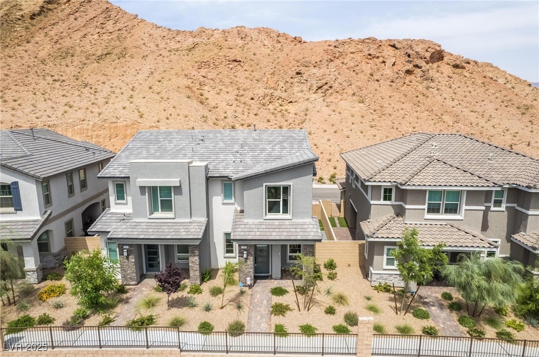 128 Kimberlite Drive Henderson, NV 89011 - Photo 43 of 55 View of front of home featuring stucco siding, stone siding, and a mountain view