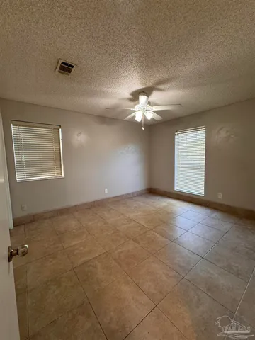 a view of an empty room with a ceiling fan