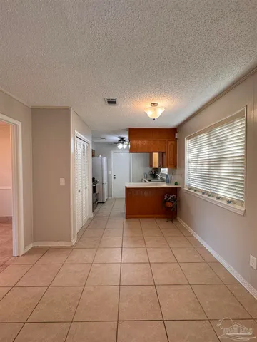 a kitchen with stainless steel appliances a refrigerator and a stove top oven