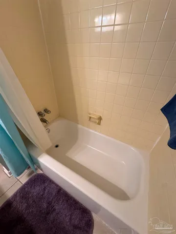 a white toilet sitting next to a white sink