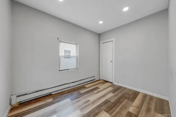 a view of a room with a wooden floor and a window