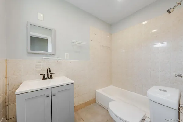a bathroom with a sink a toilet and mirror