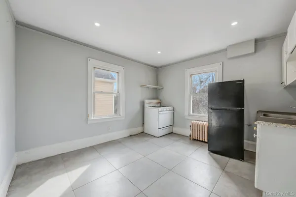 a kitchen with a refrigerator and a stove top oven