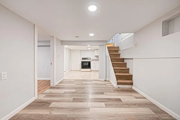 a view of a livingroom with wooden floor and stairs