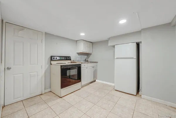 a kitchen with cabinets and white stainless steel appliances