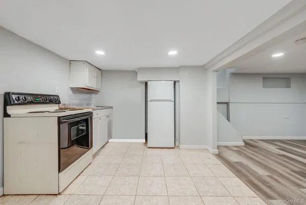 a kitchen with a stove top oven and cabinets