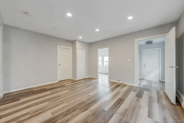 a view of an empty room with wooden floor