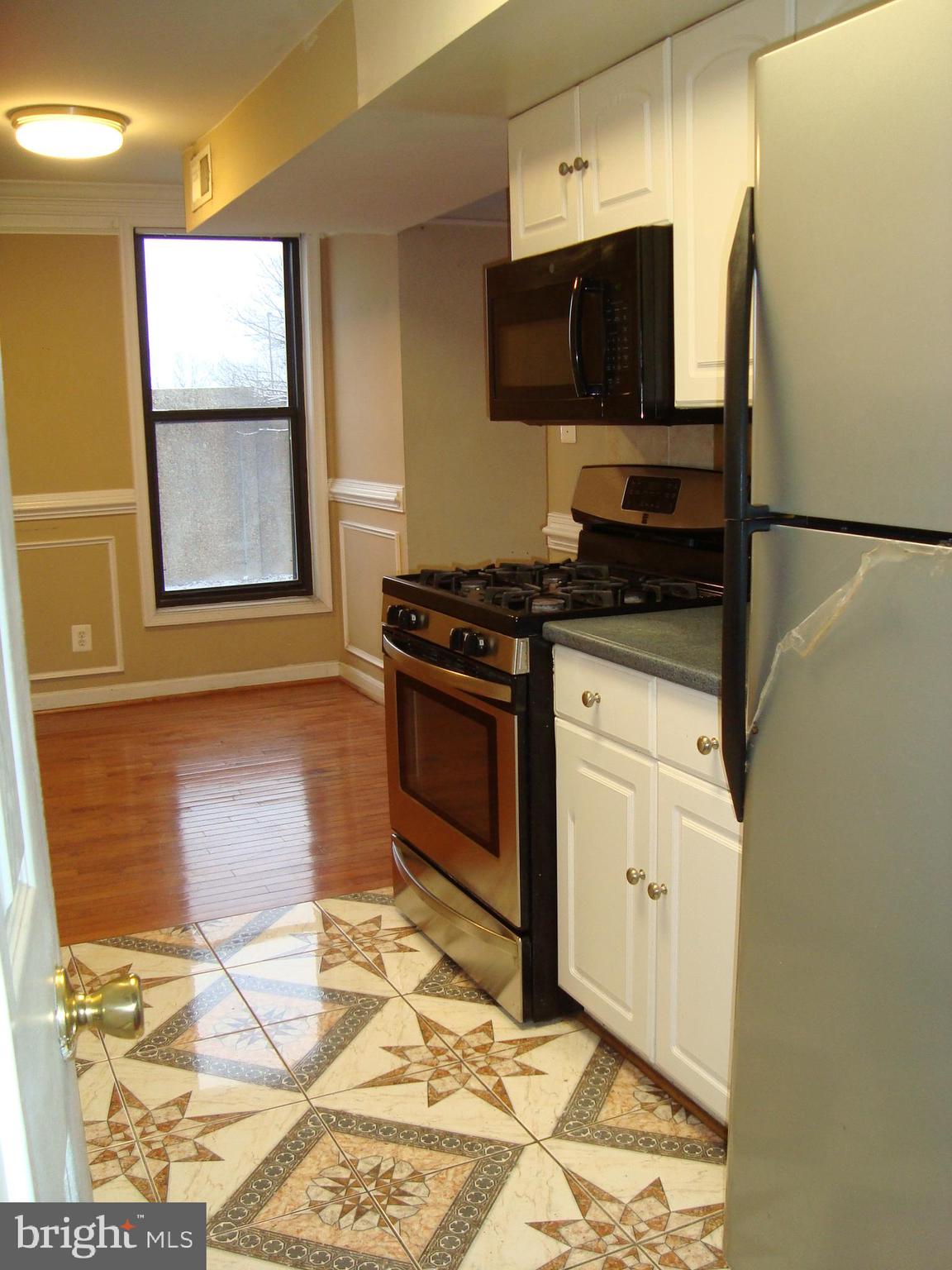 102 Duvall Lane, Unit 6202 Gaithersburg, MD 20877 - Photo 11 of 23 a kitchen with granite countertop a stove top oven cabinets a sink and a counter top space