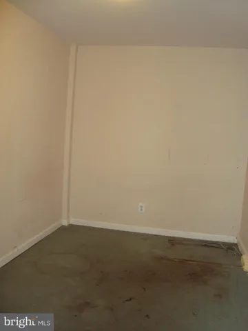 a room with gym equipment and view of kitchen