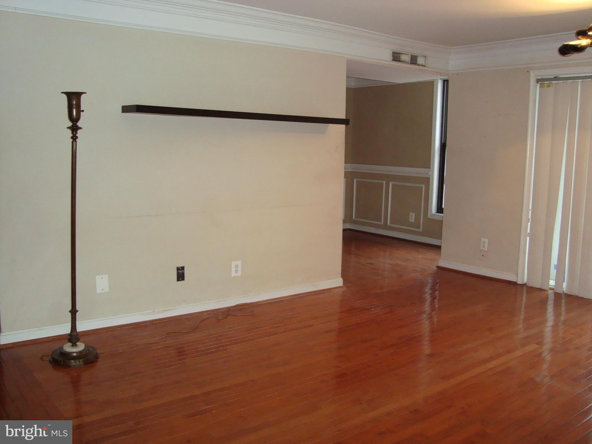102 Duvall Lane, Unit 6202 Gaithersburg, MD 20877 - Photo 4 of 23 a view of an empty room with wooden floor and a window