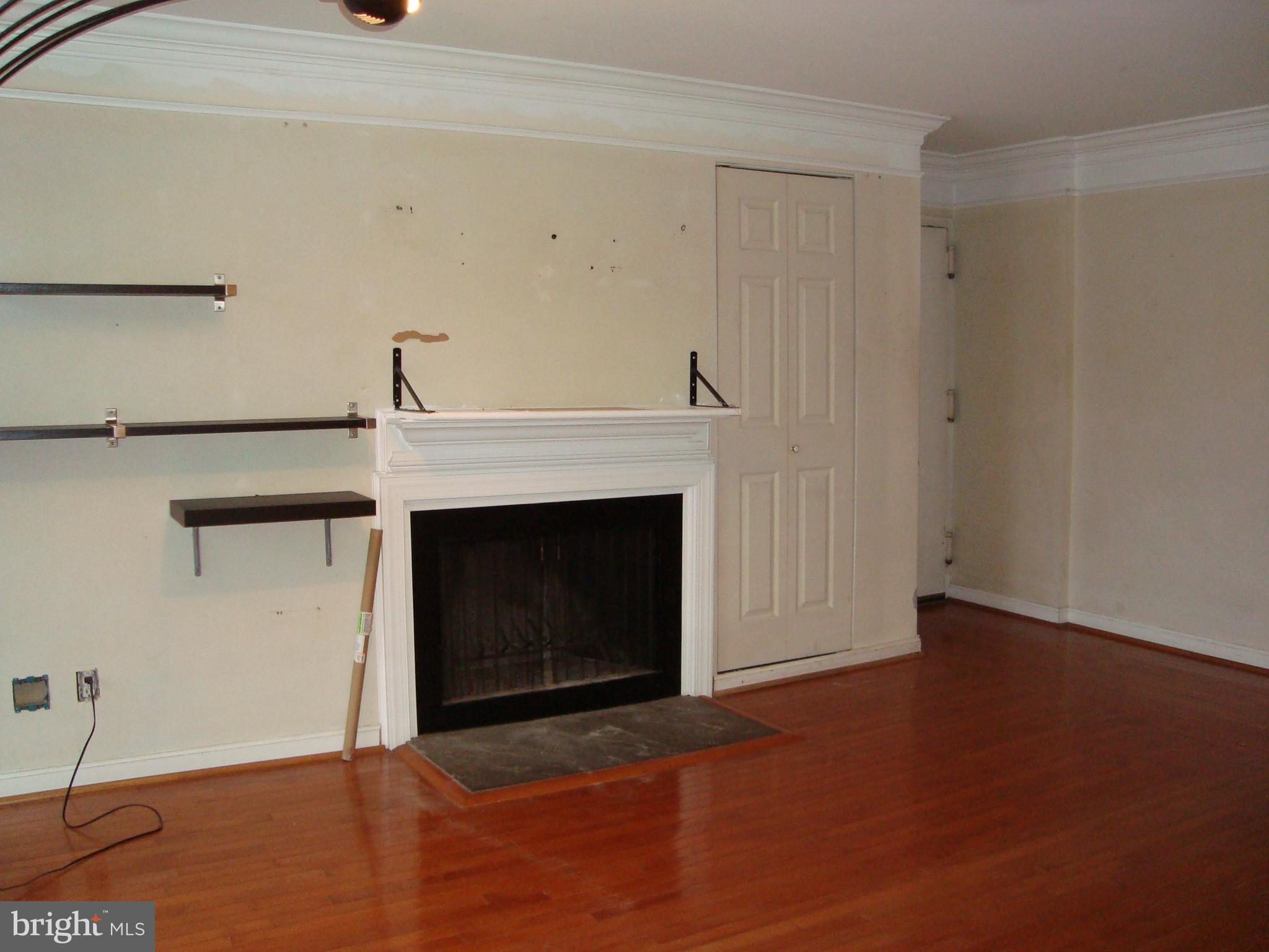 102 Duvall Lane, Unit 6202 Gaithersburg, MD 20877 - Photo 5 of 23 a view of an empty room with wooden floor and a fireplace
