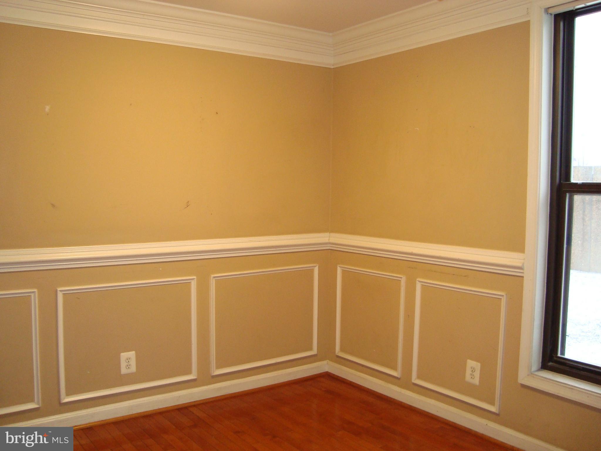 102 Duvall Lane, Unit 6202 Gaithersburg, MD 20877 - Photo 7 of 23 a view of an empty room with wooden floor and a window