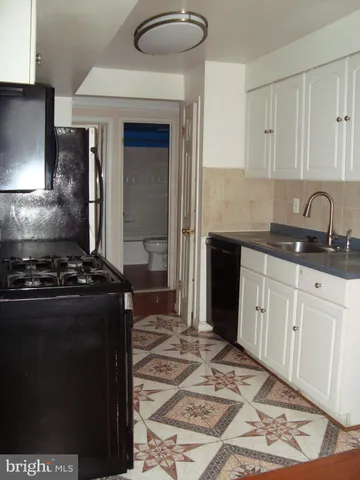 a kitchen with a stove and a sink