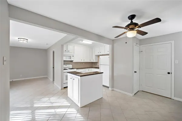 a kitchen with stainless steel appliances granite countertop a stove a refrigerator and a cabinets