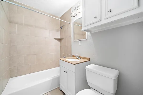 a bathroom with a sink a toilet and bathtub