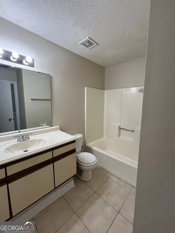 a bathroom with a double vanity sink toilet and shower