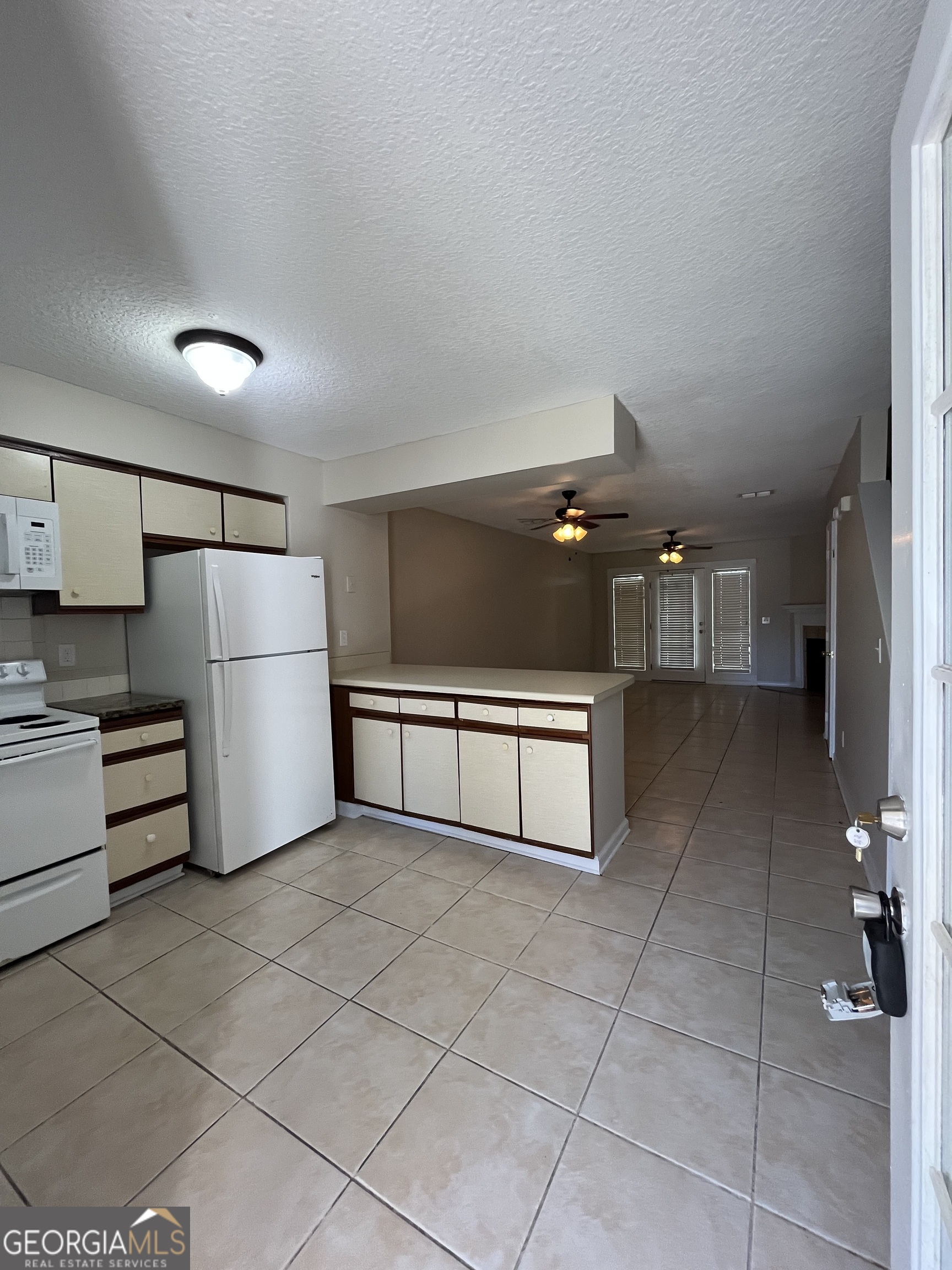 109 Inlet Reach Circle St. Marys, GA 31558 - Photo 2 of 16 a kitchen with refrigerator and cabinets