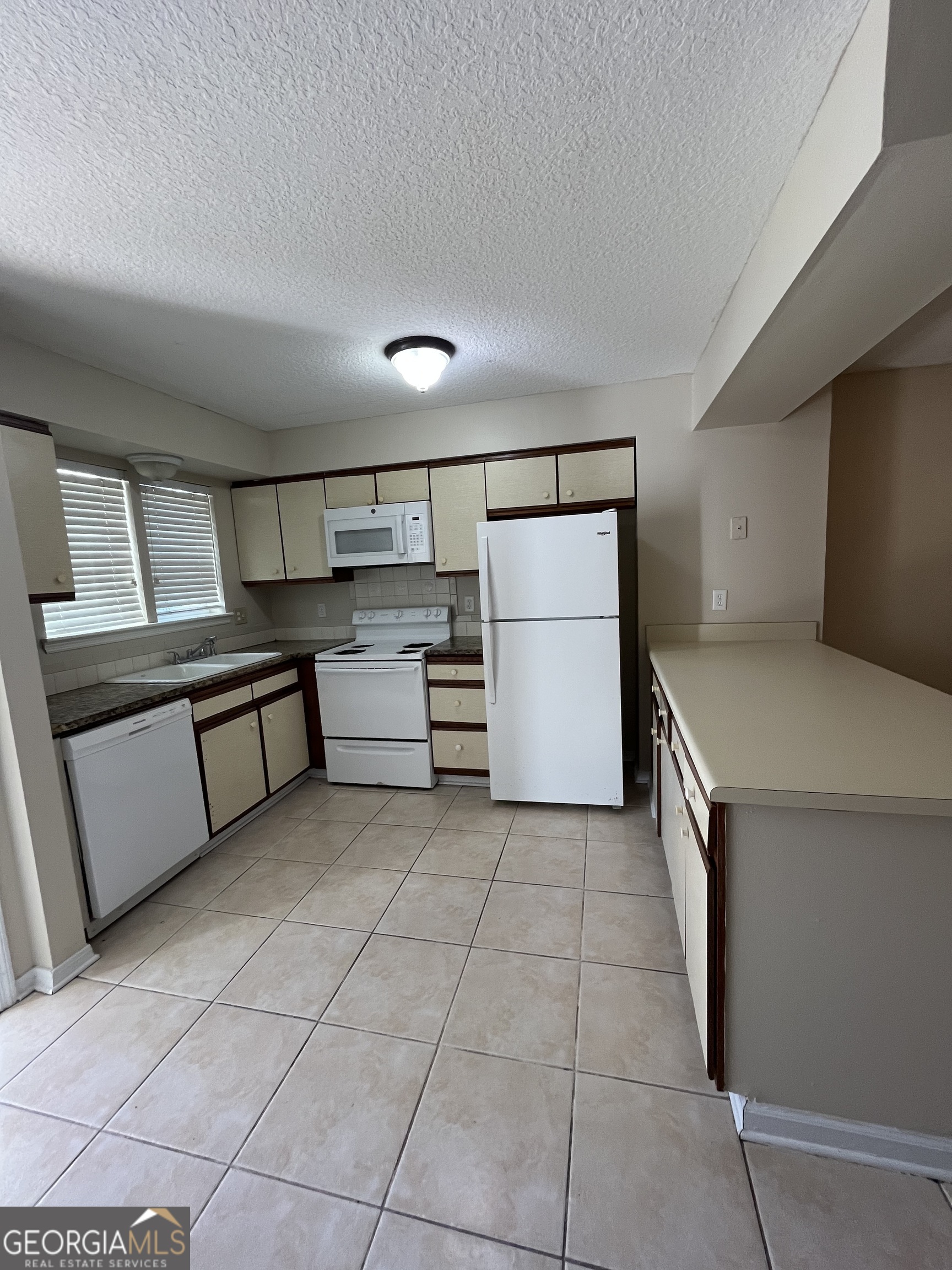 109 Inlet Reach Circle St. Marys, GA 31558 - Photo 3 of 16 a kitchen with stainless steel appliances granite countertop a refrigerator and a stove top oven