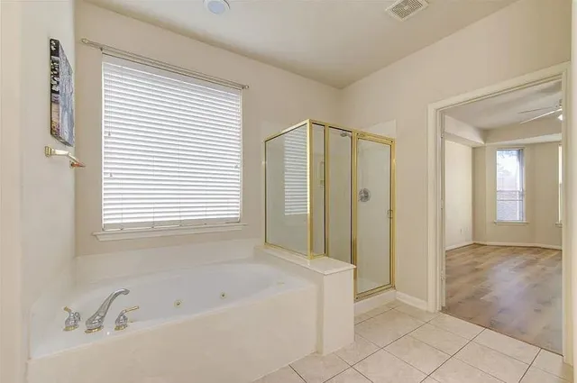 a bathroom with a bathtub and a shower