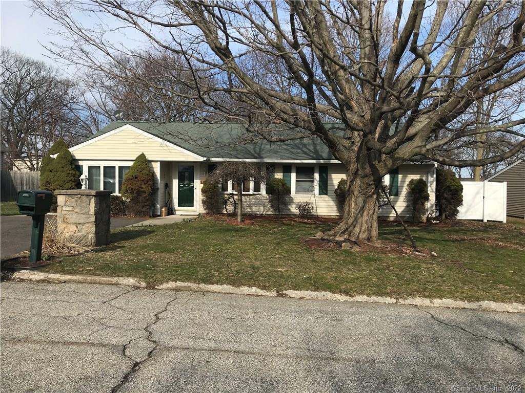 71 Little Deer Road Bridgeport, CT 06606 - Photo 1 of 1 a front view of a house with a yard garage and large tree
