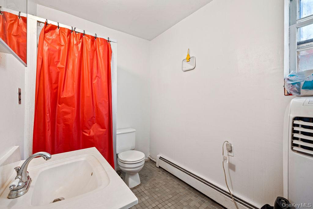 309 Gate Hill Coop Road Stony Point, NY 10980 - Photo 15 of 23 a white toilet sitting next to a shower curtain