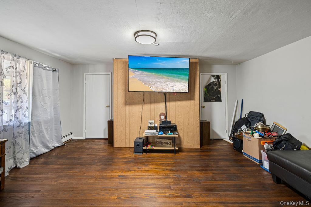 309 Gate Hill Coop Road Stony Point, NY 10980 - Photo 5 of 23 a room with wooden floor and a large window