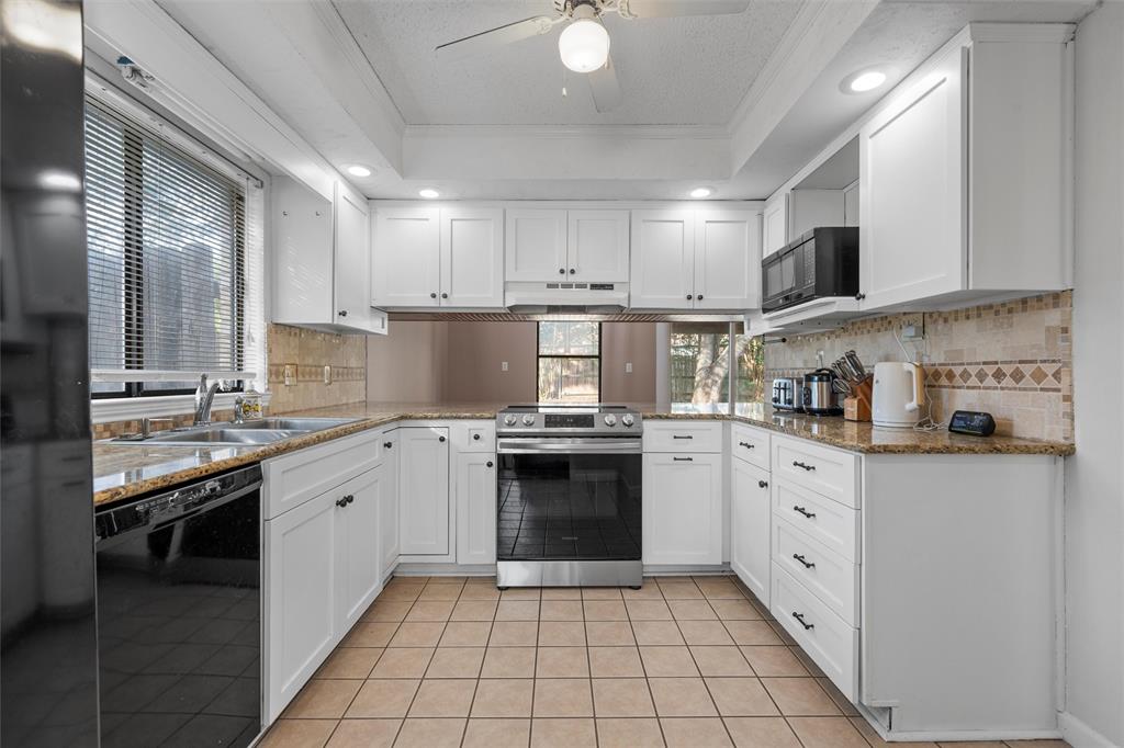 1010 December Drive Hewitt, TX 76643 - Photo 11 of 25 a kitchen with stainless steel appliances granite countertop a stove sink and cabinets