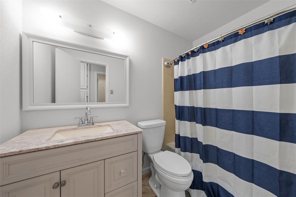 1010 December Drive Hewitt, TX 76643 - Photo 15 of 25 a bathroom with a sink a toilet a shower and a mirror