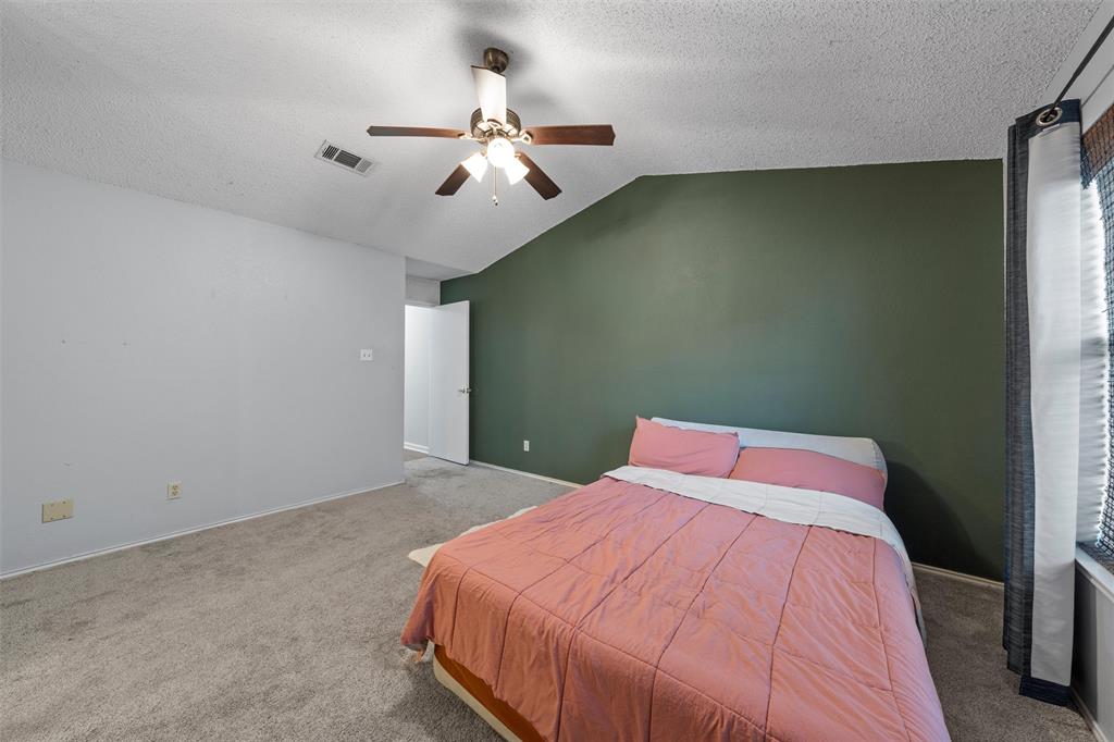 1010 December Drive Hewitt, TX 76643 - Photo 17 of 25 a bedroom with a bed and chandelier