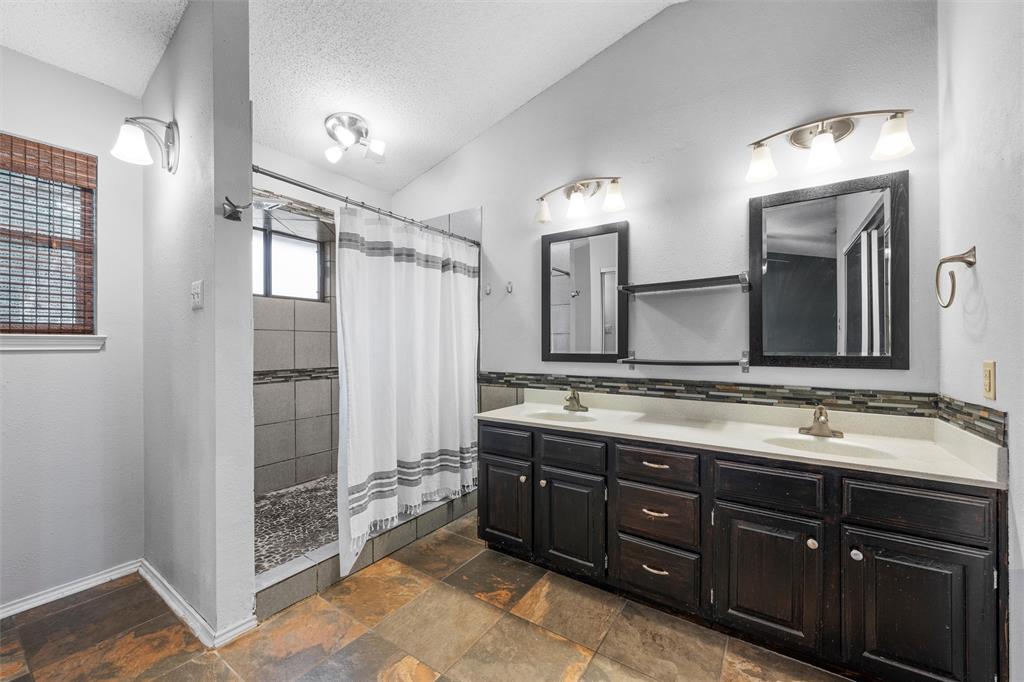 1010 December Drive Hewitt, TX 76643 - Photo 18 of 25 a bathroom with a double vanity sink and a mirror