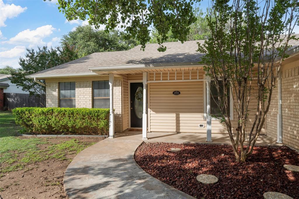 1010 December Drive Hewitt, TX 76643 - Photo 2 of 25 a front view of a house with a garden