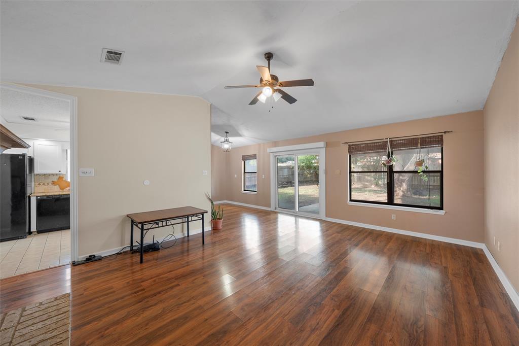 1010 December Drive Hewitt, TX 76643 - Photo 5 of 25 a view of an empty room with wooden floor and a window