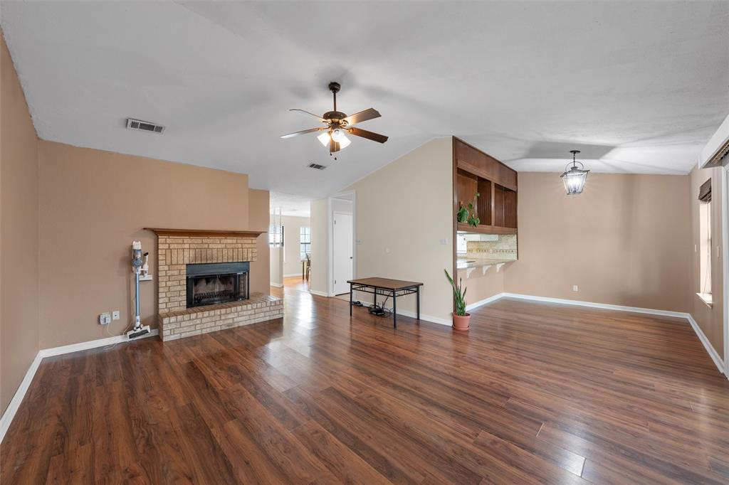 1010 December Drive Hewitt, TX 76643 - Photo 6 of 25 a view of a livingroom with a fireplace a ceiling fan and wooden floor
