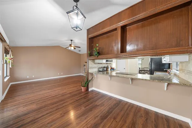 a kitchen with a sink appliances and cabinets