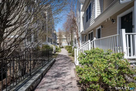 a view of a pathway that has wooden fence