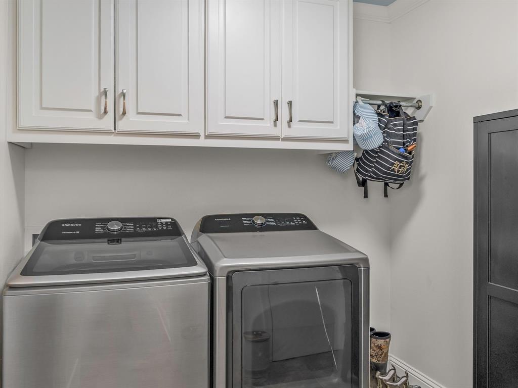 690 Lessie Drive Stonewall, LA 71078 - Photo 15 of 29 Laundry area featuring upper cabinetry with brushed nickel hardware, light-colored walls, and a built-in wall rack