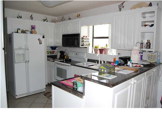 3799 East A Santa Rosa Beach, Unit 10G C30 Santa Rosa Beach, FL 32459 - Photo 6 of 13 a kitchen with granite countertop a sink appliances cabinets and a counter top space