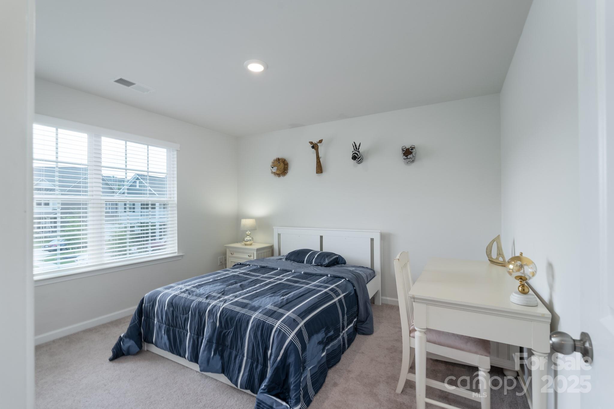 1782 Wildwood Terrace Trail Tega Cay, SC 29708 - Photo 21 of 47 a bedroom with a bed and a window