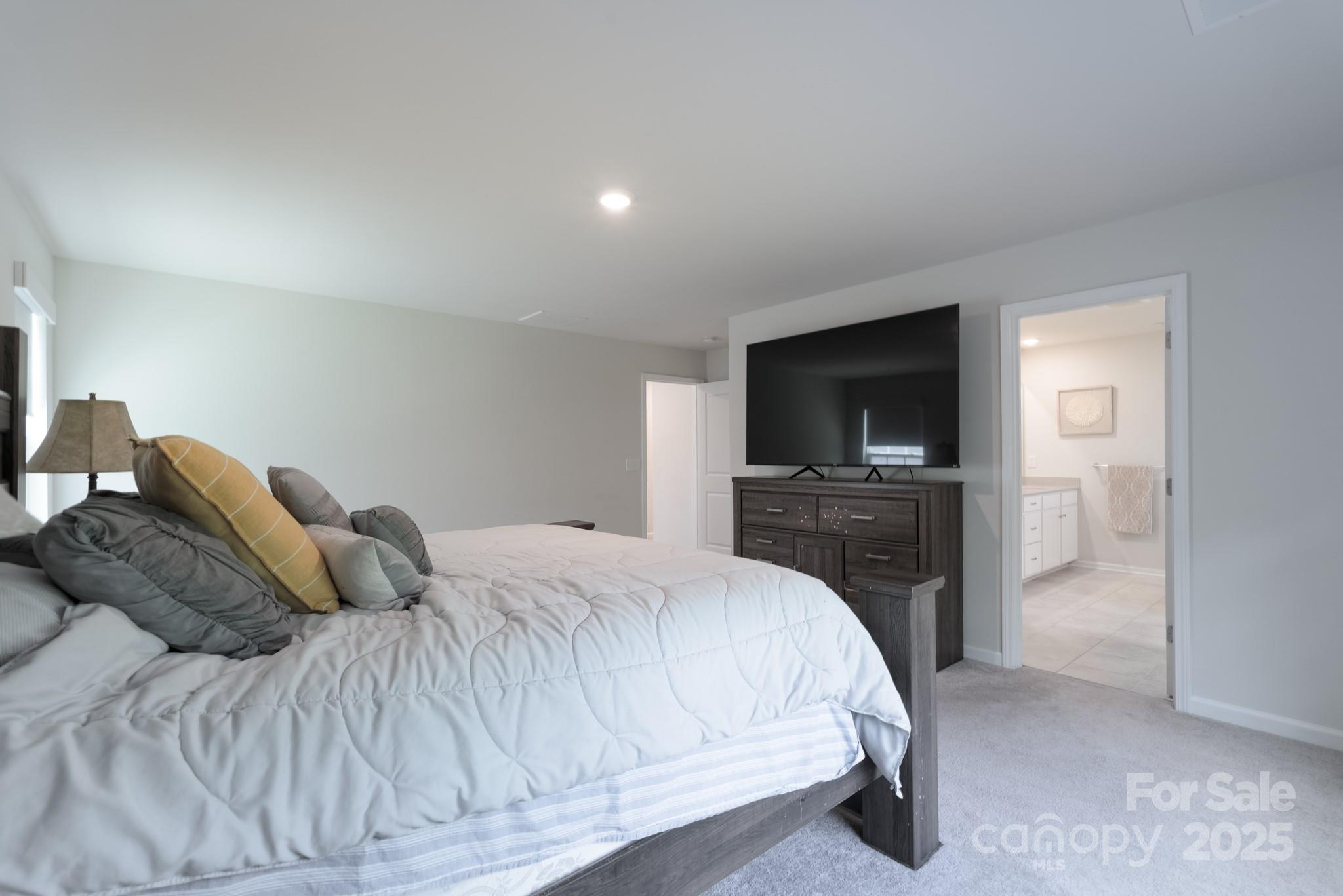 1782 Wildwood Terrace Trail Tega Cay, SC 29708 - Photo 25 of 47 a bedroom with a bed and a flat screen tv