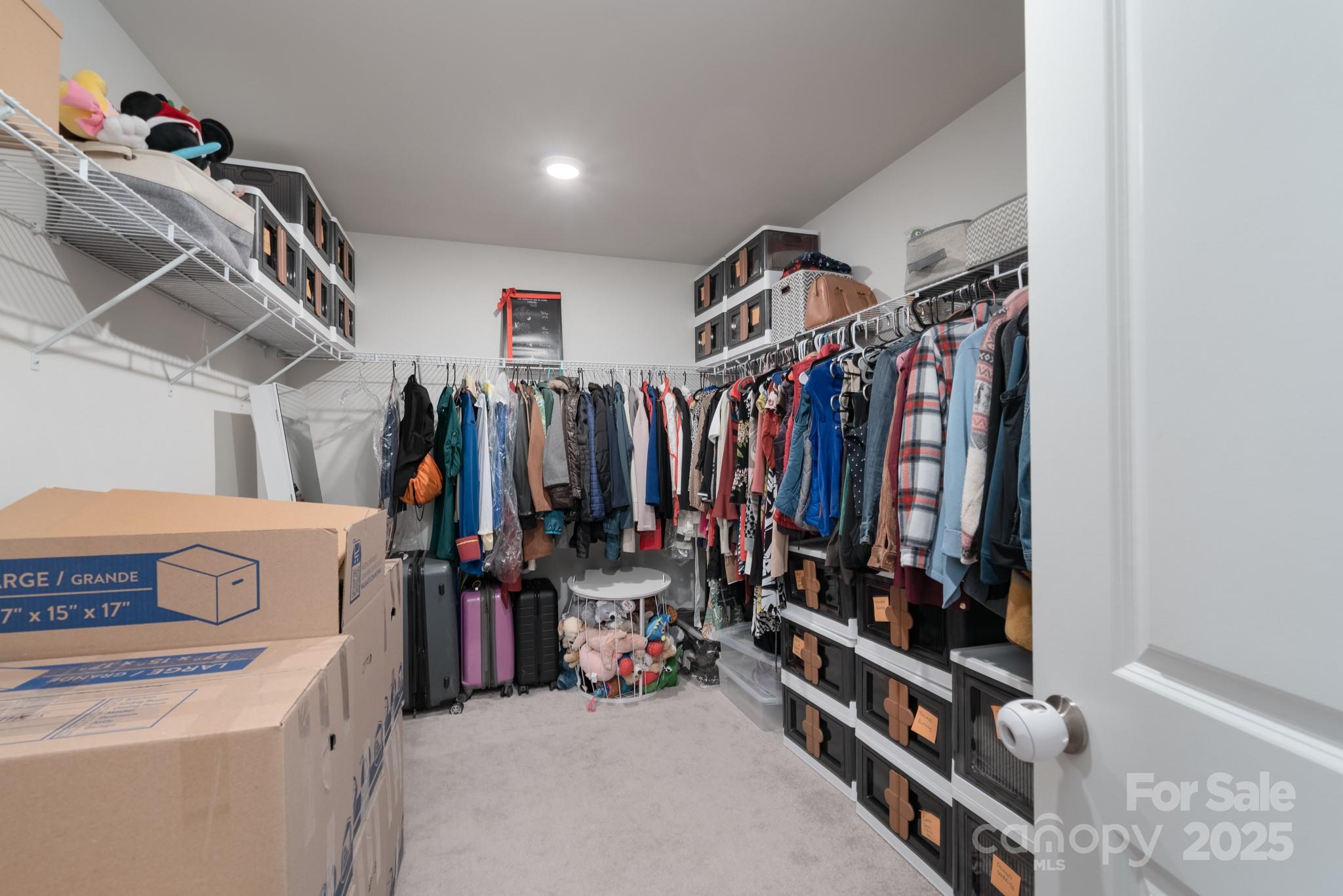1782 Wildwood Terrace Trail Tega Cay, SC 29708 - Photo 28 of 47 a view of walk in closet with clothes and shoes