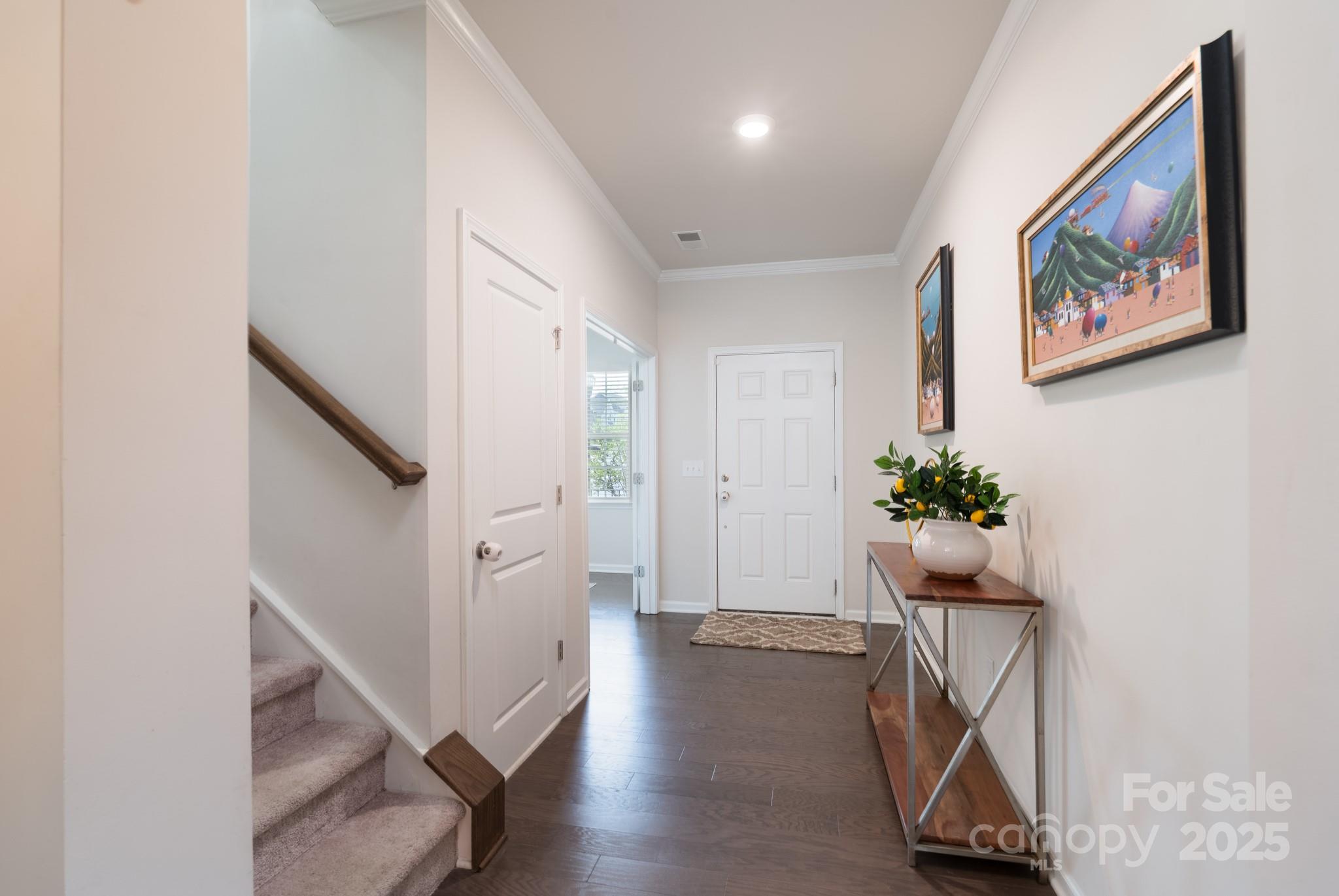 1782 Wildwood Terrace Trail Tega Cay, SC 29708 - Photo 4 of 47 a hallway with wooden floor and stairs